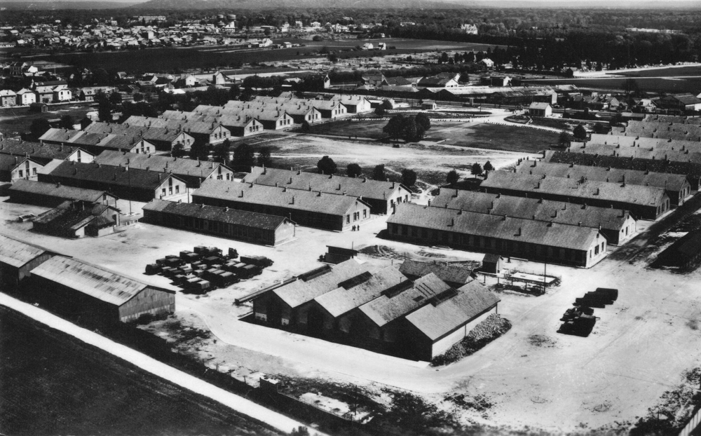 La caserne de Royallieu en 1957 ; au deuxième plan, les six grands bâtiments alignés du quartier C, qui semblent avoir souvent servi au regroupement des internés sélectionnés pour la prochaine déportation. L’enceinte et les miradors du camp ont disparu (les deux hangars en bas à gauche n’existaient pas).